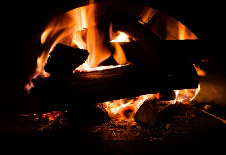 a wood fire burning inside of a fireplace