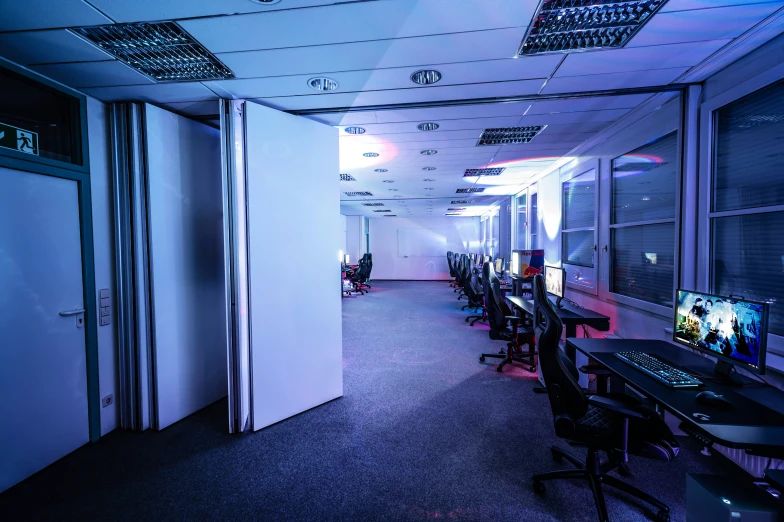 an office with long tables and computer screens