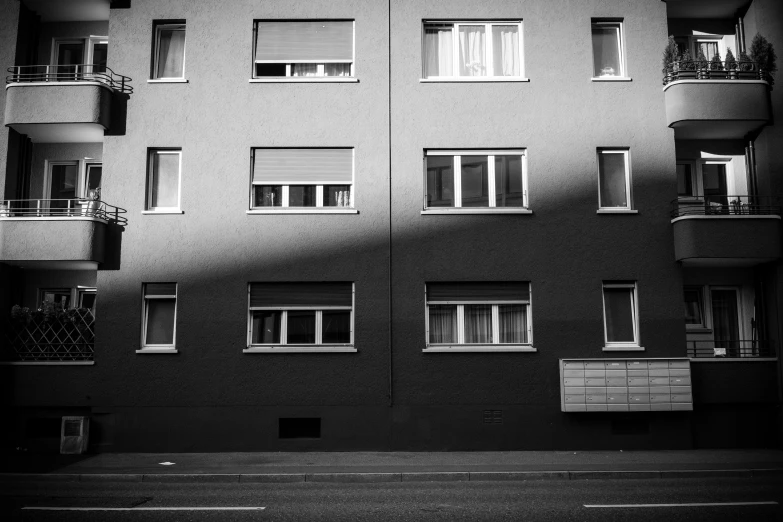 the building has windows with different balconies