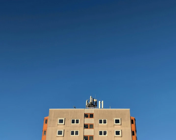 an apartment building with a parking meter in the foreground