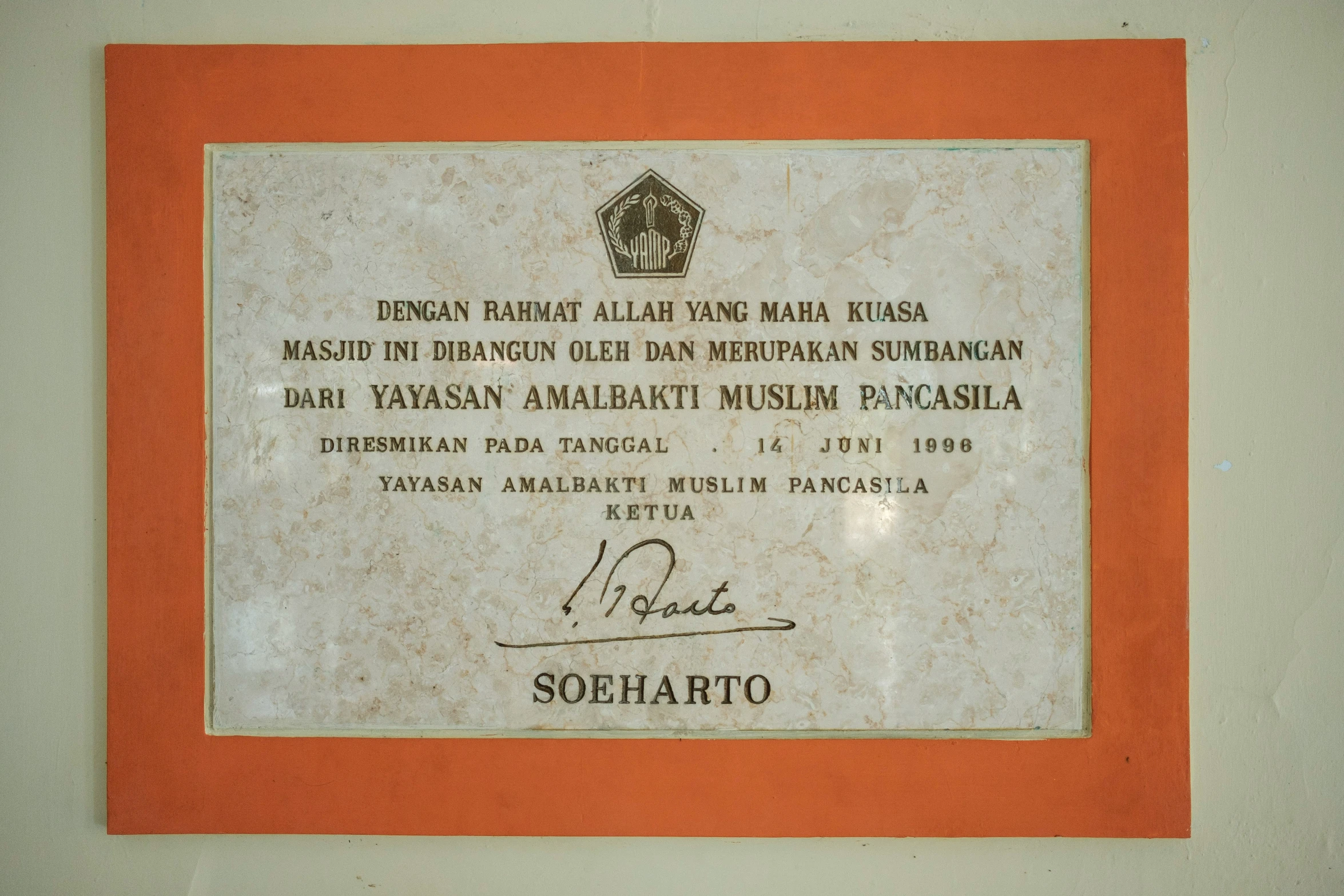 a plaque in a red frame on the wall