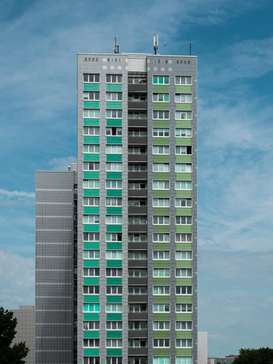 an apartment building with a green second floor window