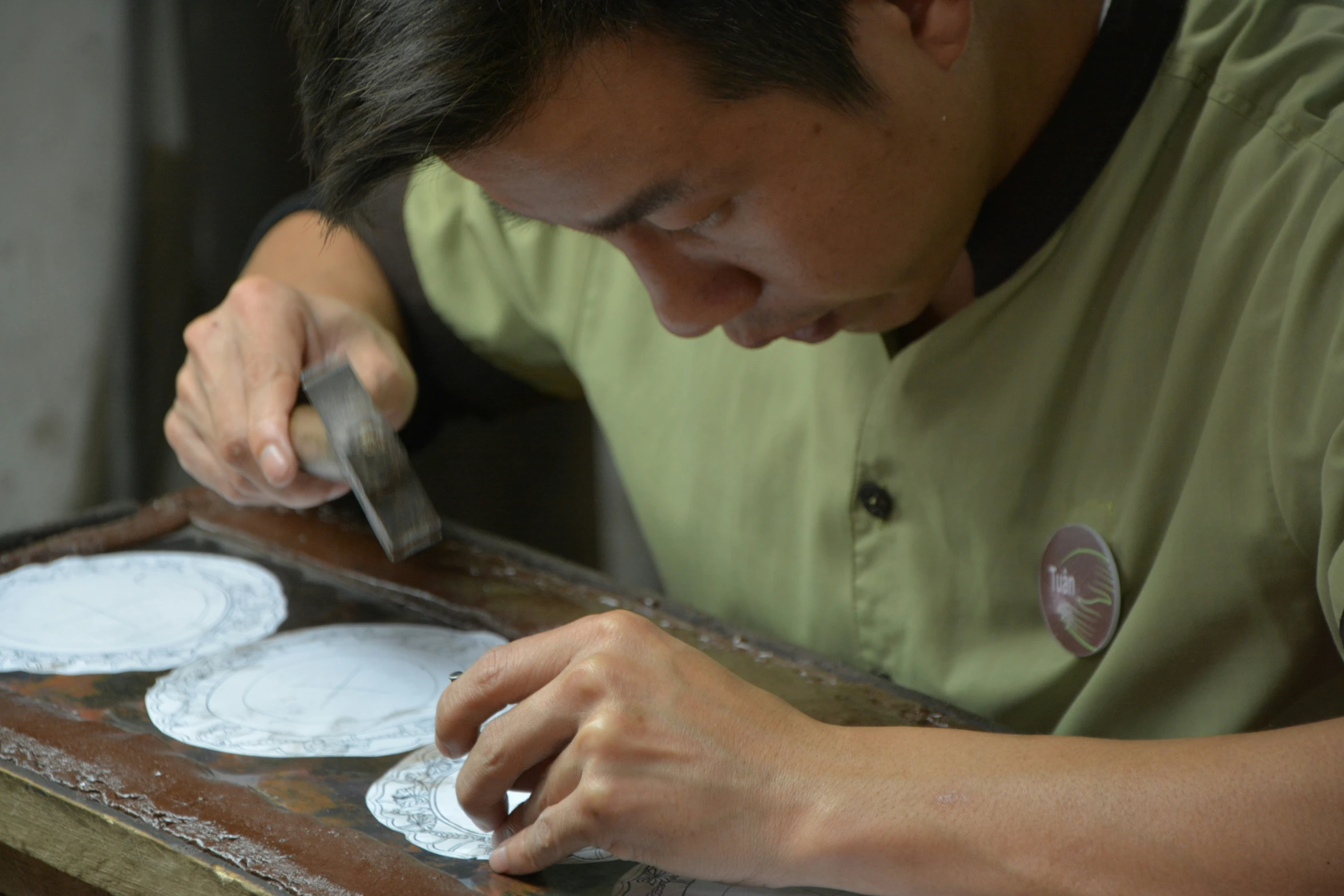 a man is working on a piece of paper that he made