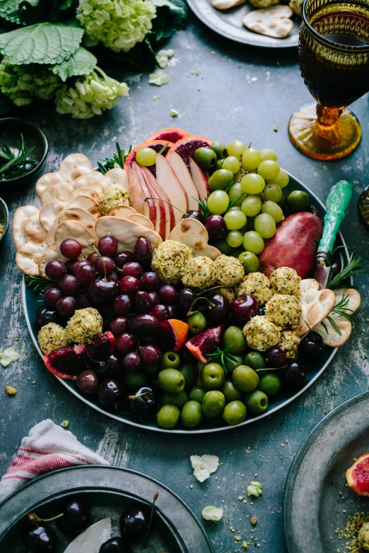 a plate full of gs and various fruit sitting on top of plates