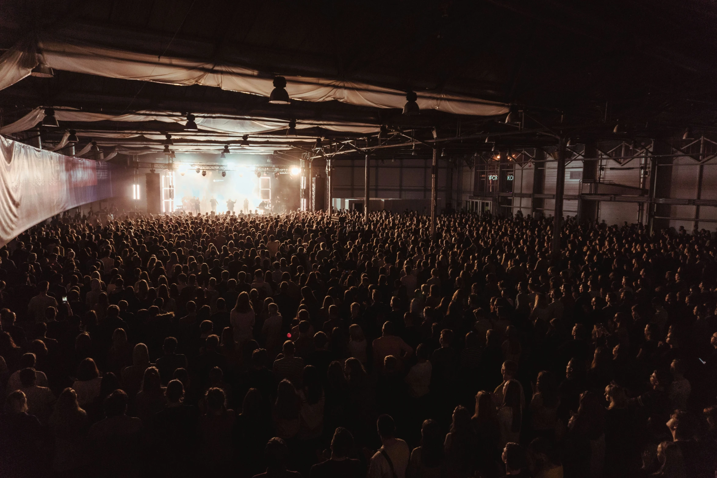 a crowd of people is in a dark room