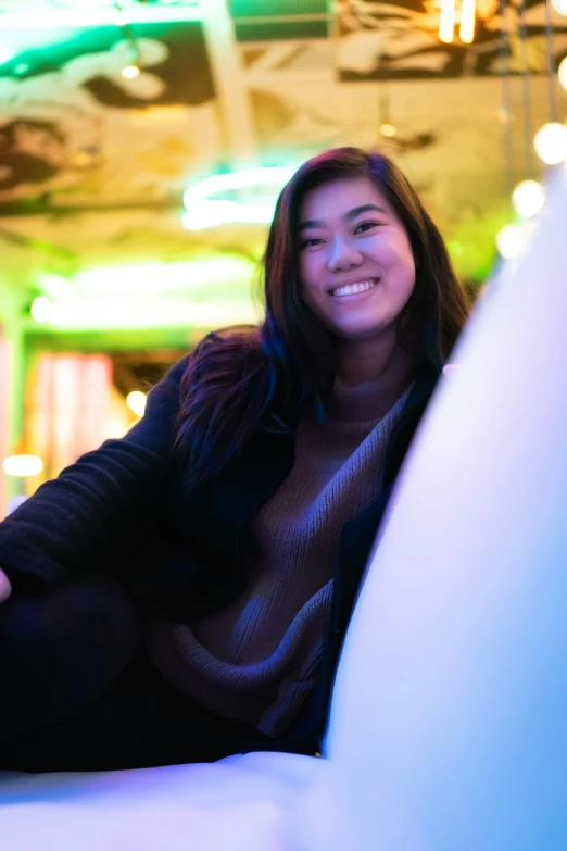 a woman that is sitting down next to a table