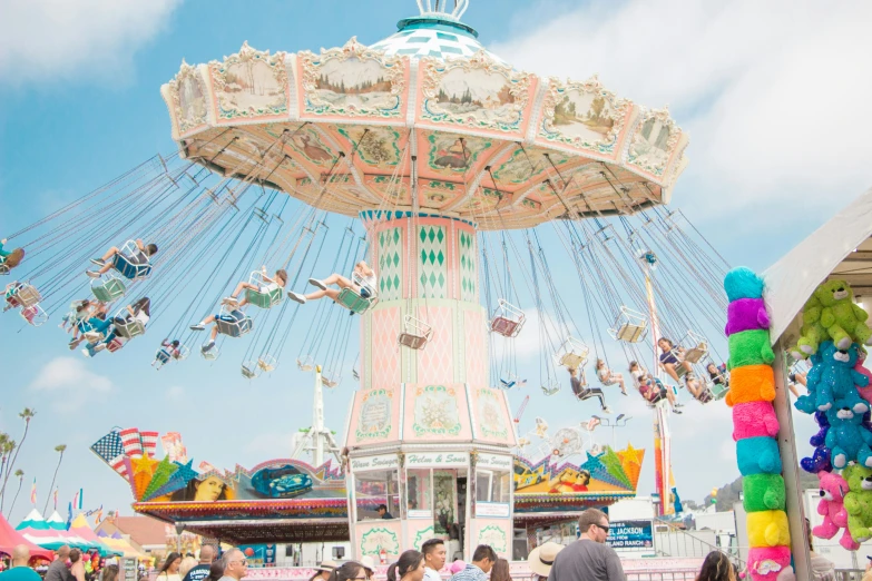 a crowd of people around a carnival ride