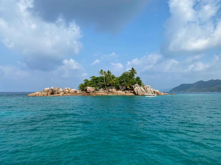 a small island on an isle in the middle of blue water