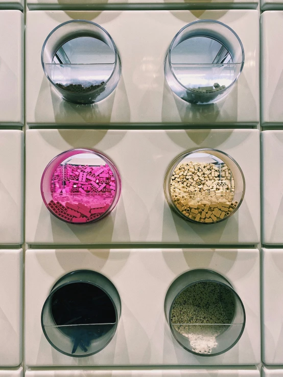 five bowls with lids and some white tiles