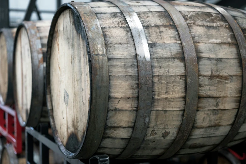 old barrels are stacked on top of each other