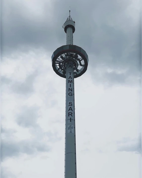 the clock is attached to the pole above the street