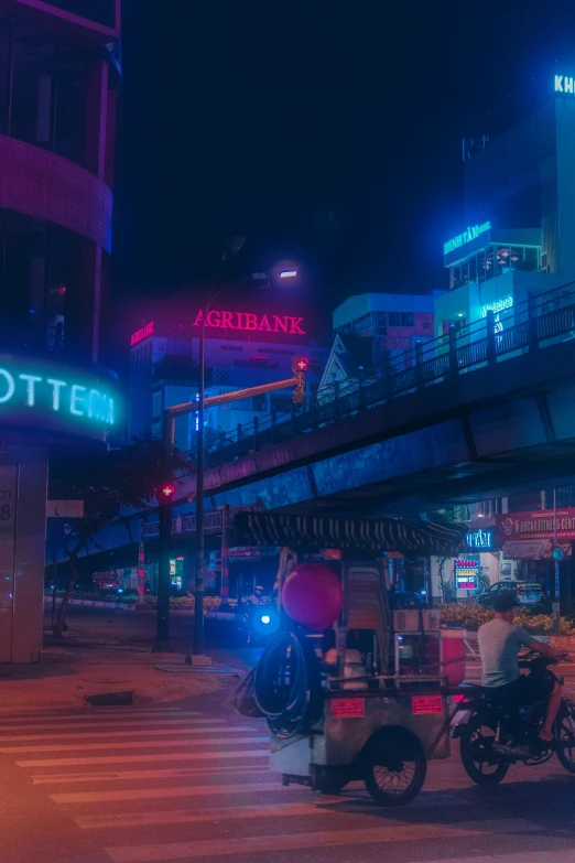 a large neon lit building on the side of a road