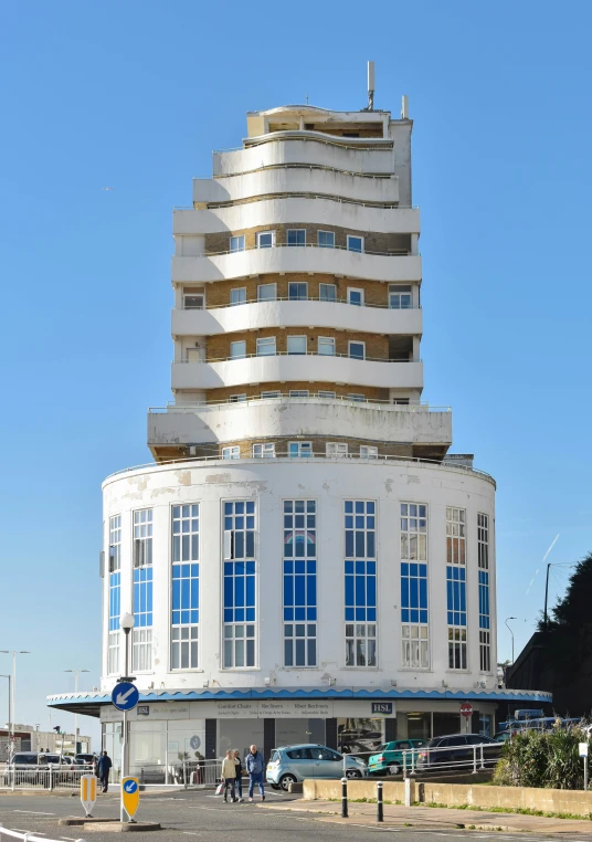 two people stand in front of a tall white building