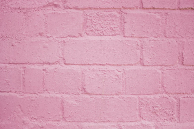 a pink brick wall with white squares and some dots
