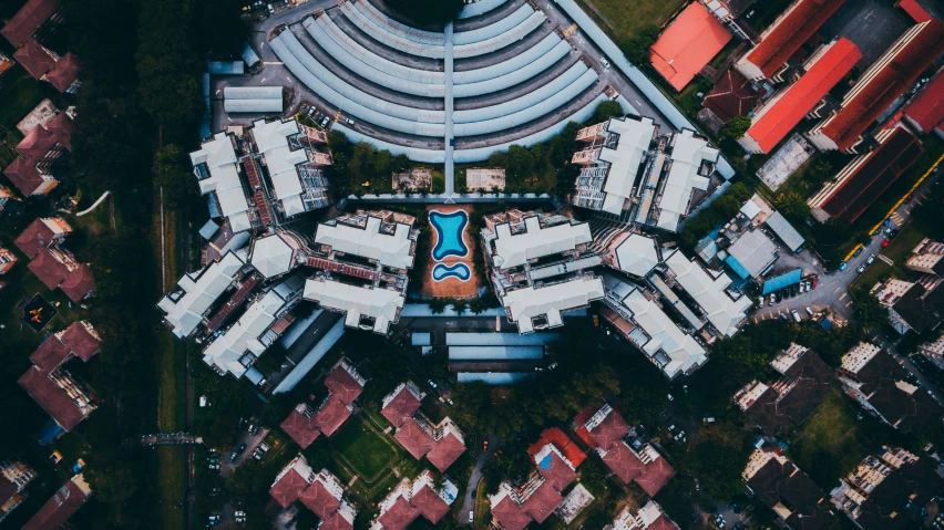 an aerial view of a swimming pool next to some buildings