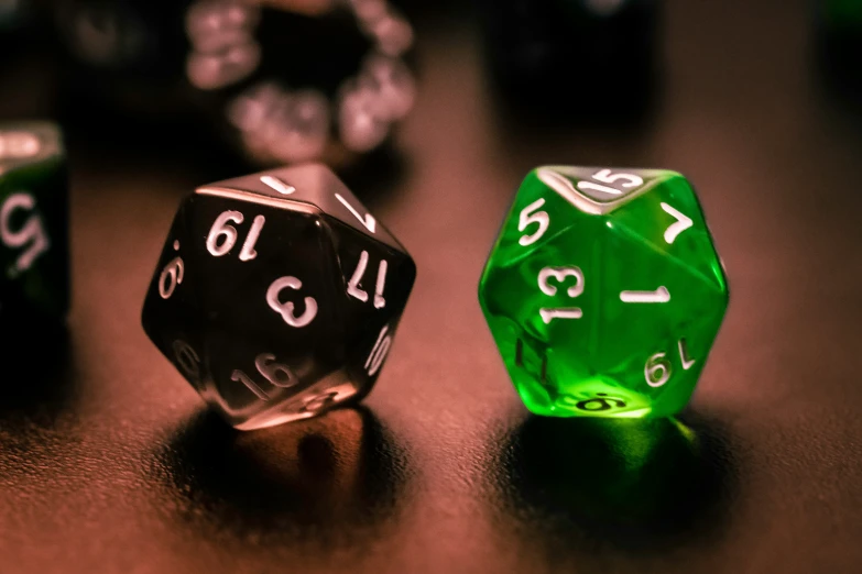 a couple of green and black dices on a table