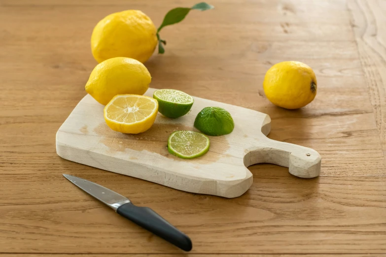 cut up lemons and lime halves sit on a  board