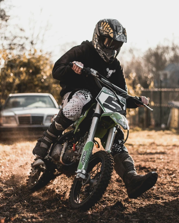 a young person riding on top of a dirt bike