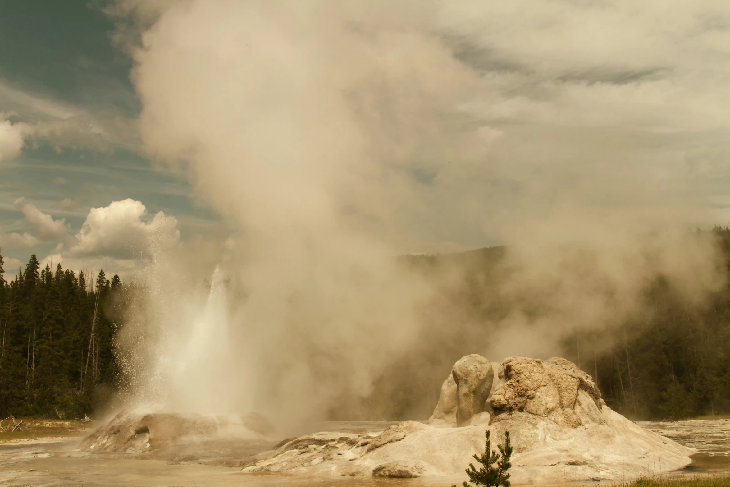 an old man in the foreground is standing in front of steam rising from his back