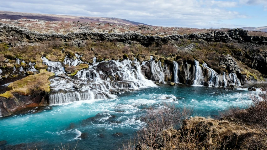 a blue river flowing between two canyons