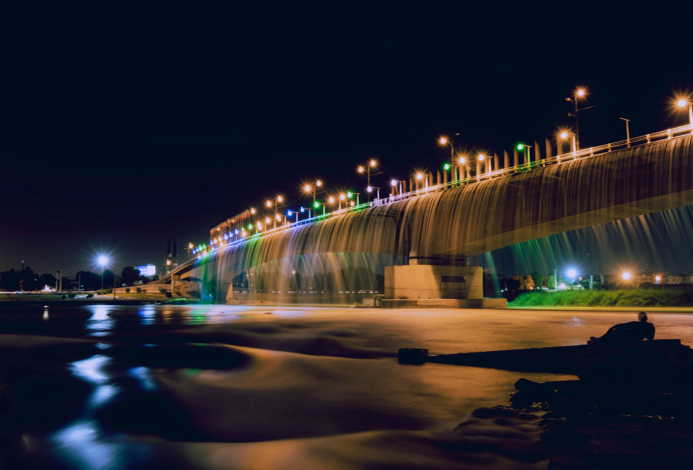 a large river flowing over the top of a bridge