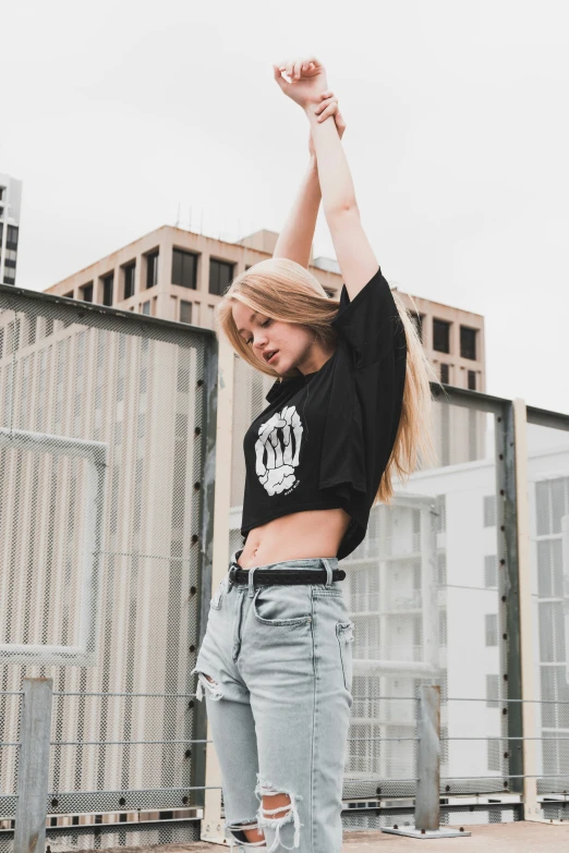 a woman wearing a hat and ripped jeans poses for a po