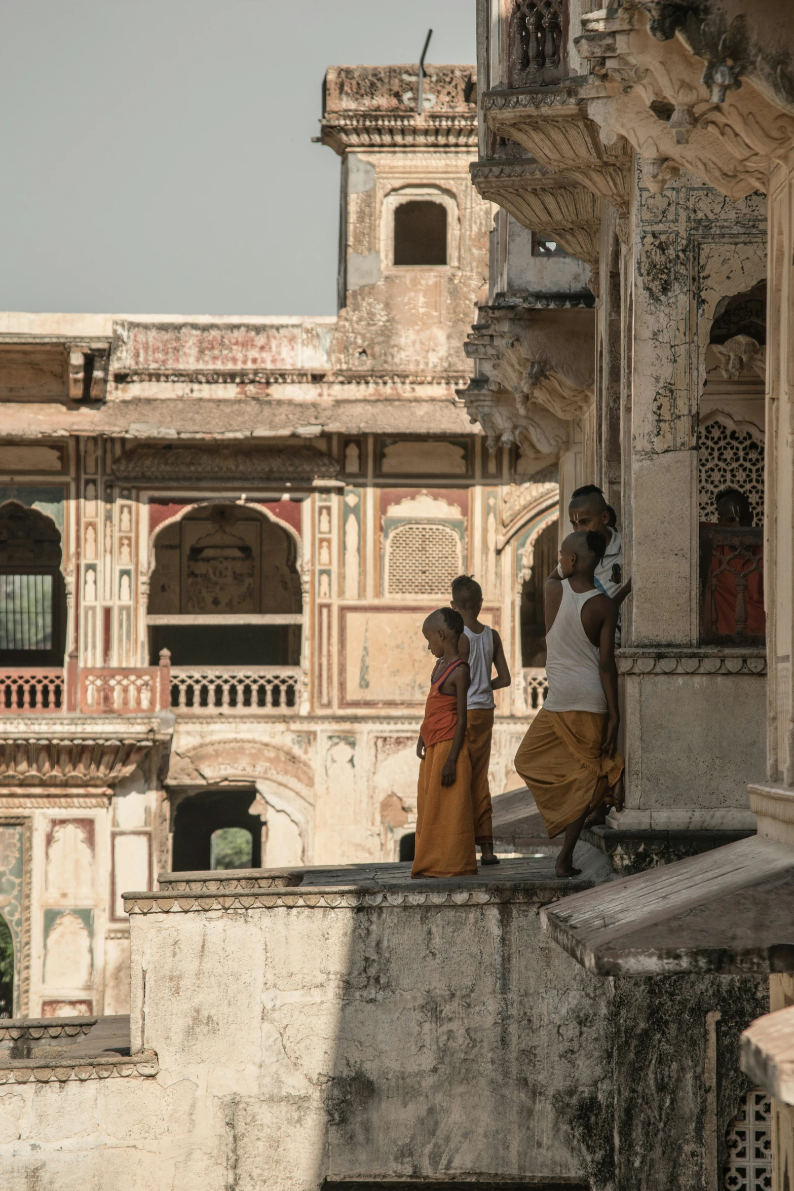 people walk up a railing in an old area