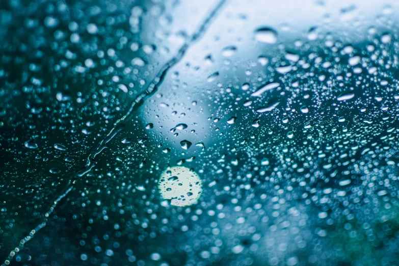 the raindrops are sitting on the windshield