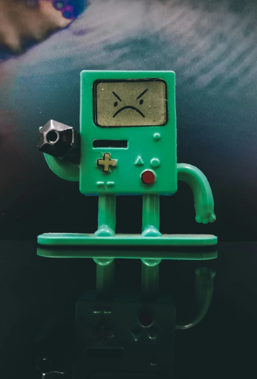 green robot with black wheels holding a green object in its hands