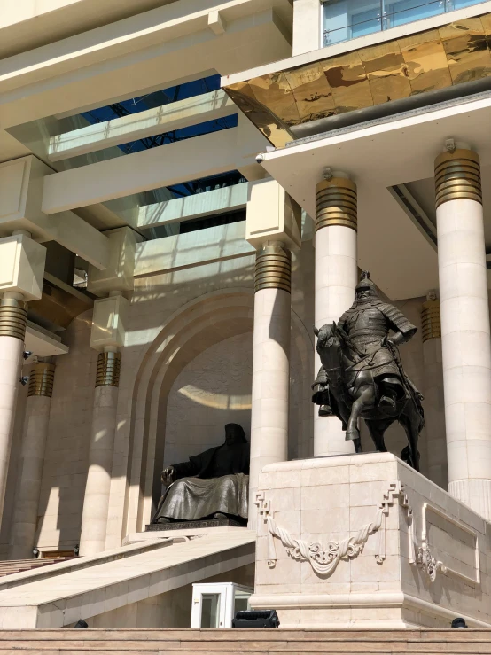 a view of the front of a building with a statue of a person on a horse