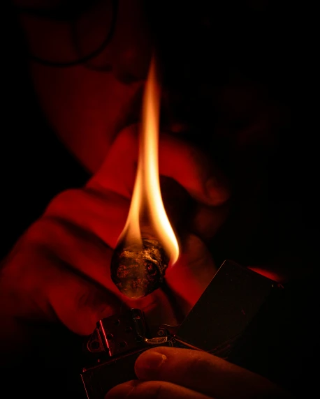 a woman holding a lighter in her hand