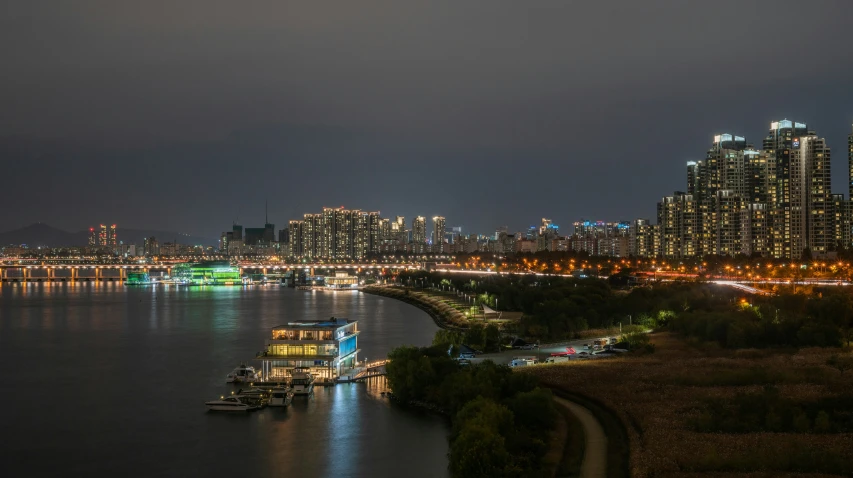 large city skyline and harbor at night with boat