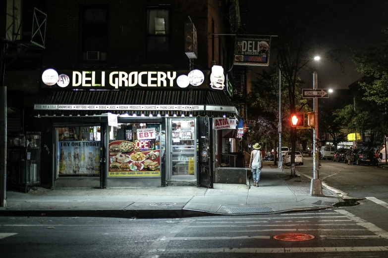 a deli grocery store on the corner of an intersection