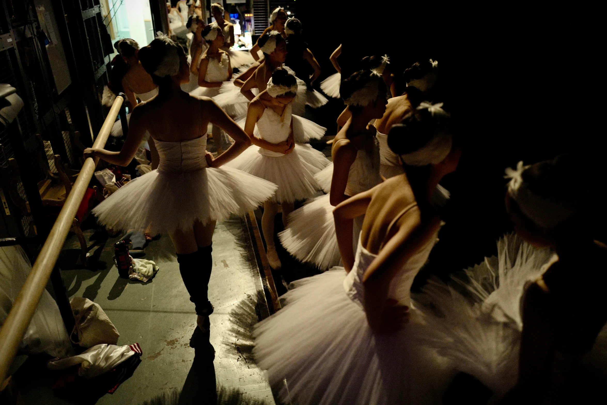 a group of ballerina dancers moving around in tutus