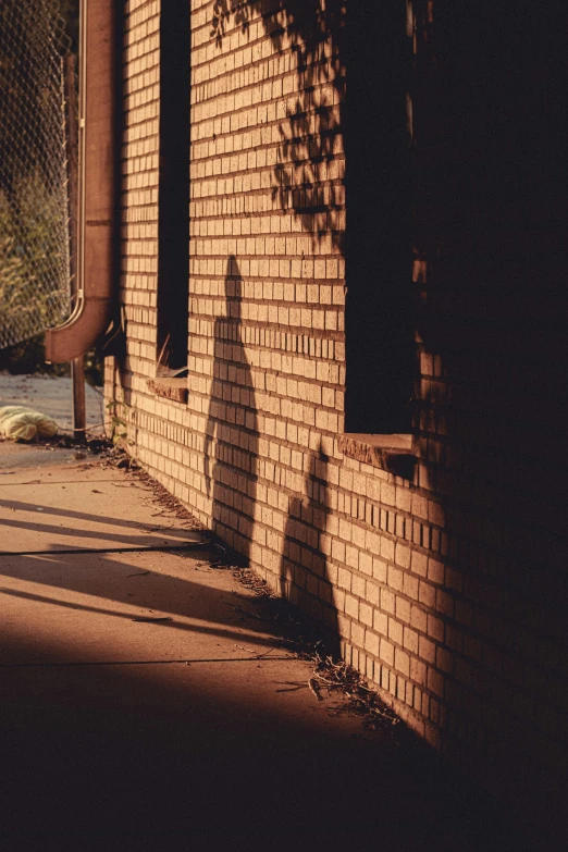 a man wearing a hat is walking down the street