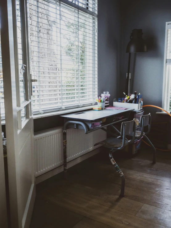 a bedroom with lots of windows and wooden floors