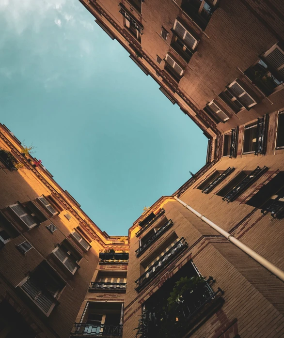 two buildings look up from their floor in a courtyard