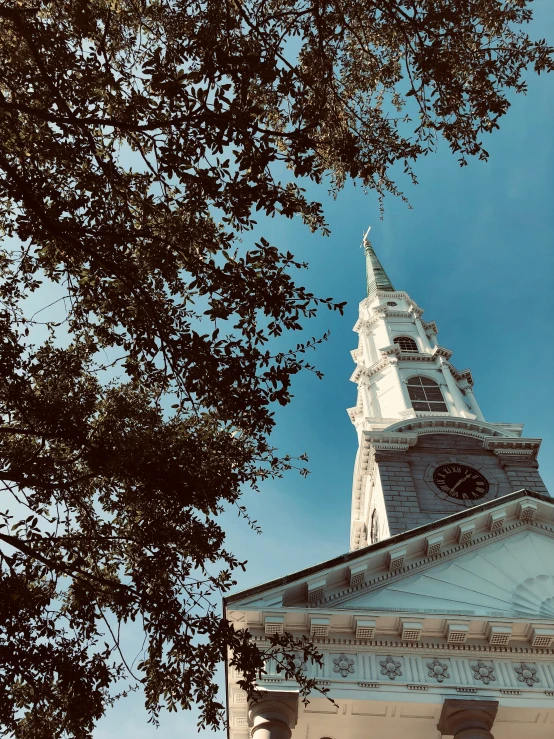 a large tower with a clock on it that is in the blue sky