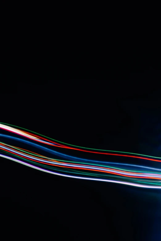 an airplane flying over a building with colorful lines