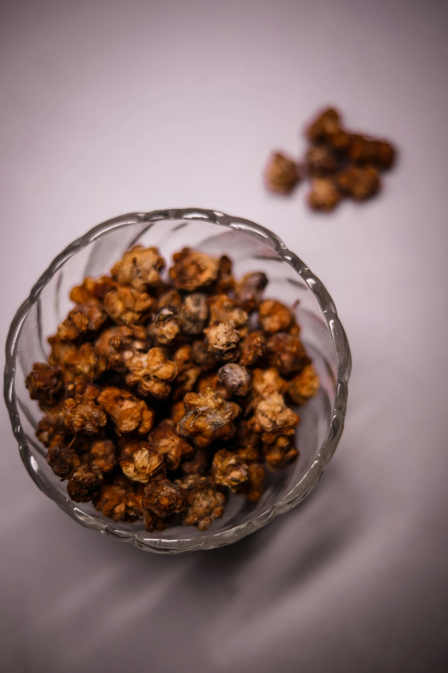 the bowl is filled with chocolate popcorn kernels