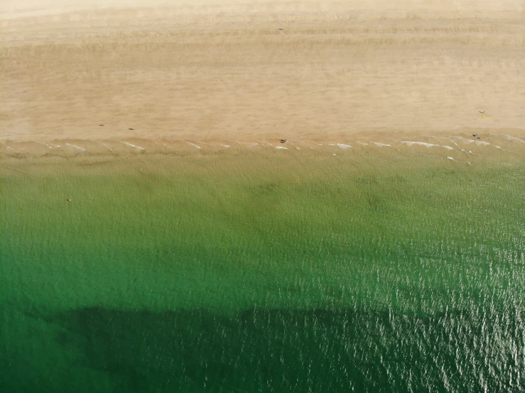 an aerial view of the water and beach