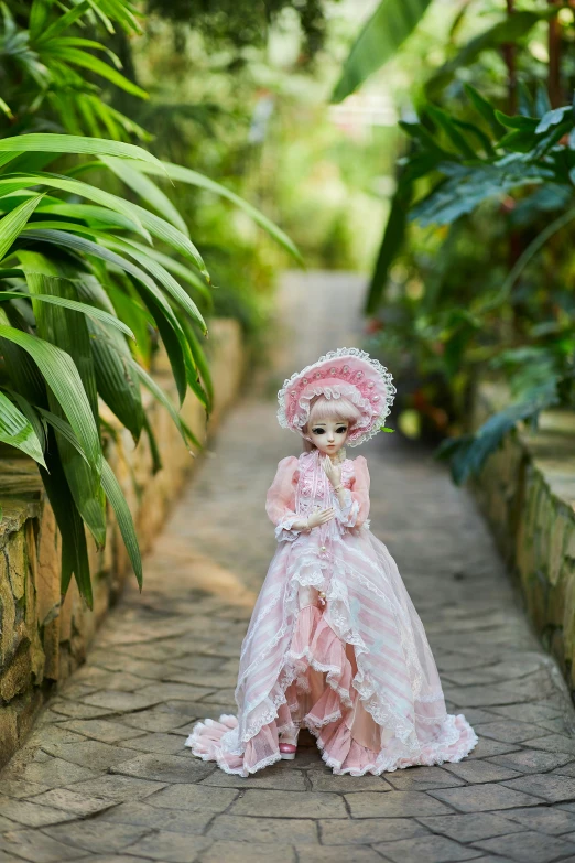 a little girl with a large face in a pink dress