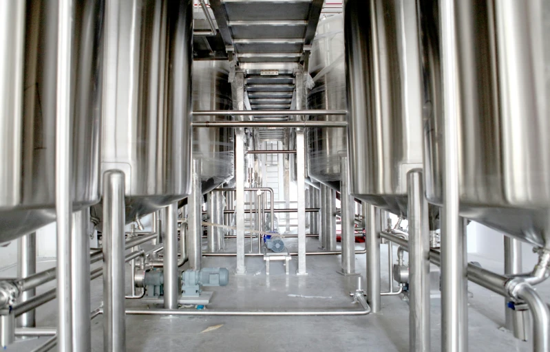 a group of stainless steel pipes are hanging in a line