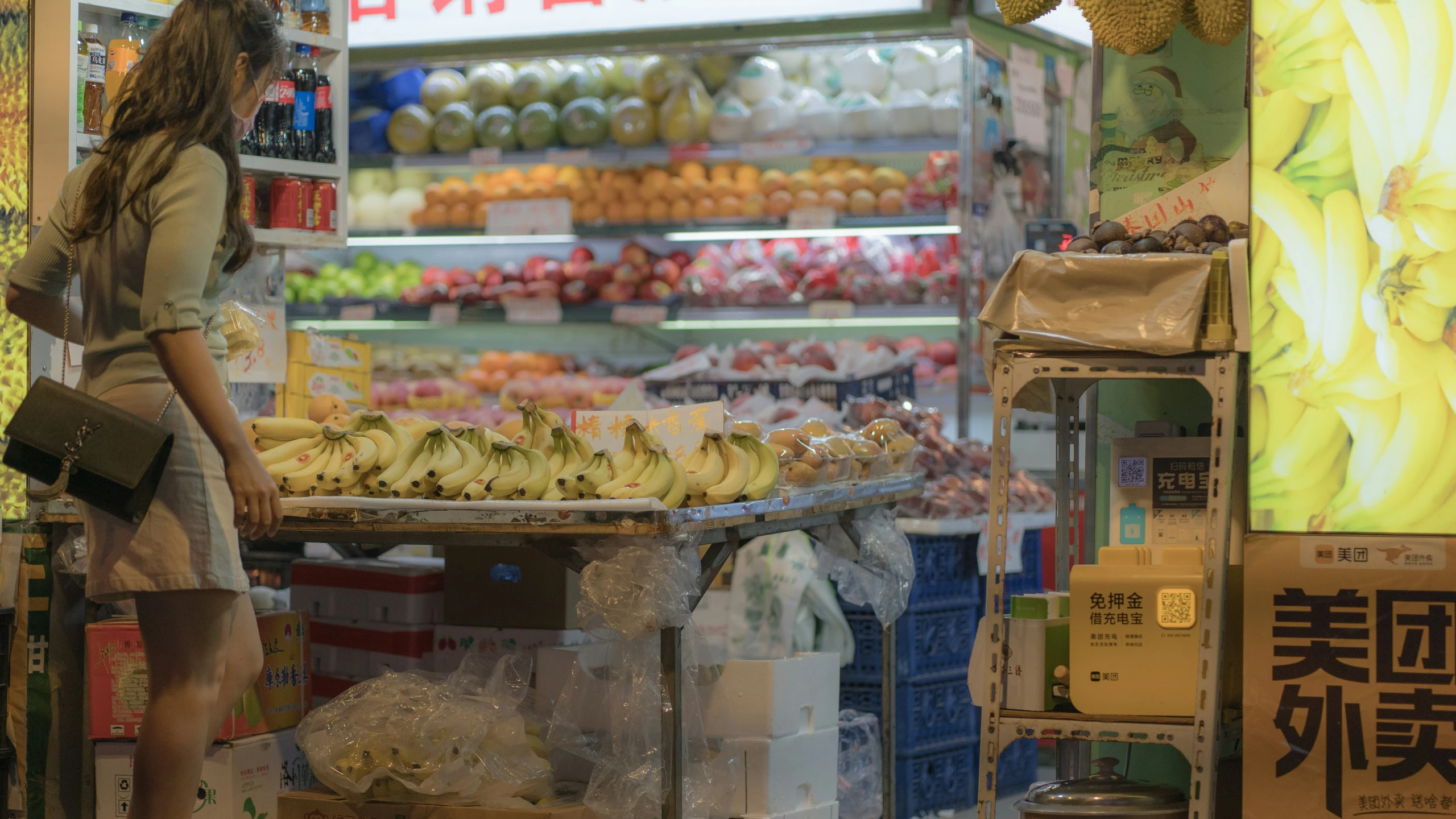 a person looking at bananas on a display at a store