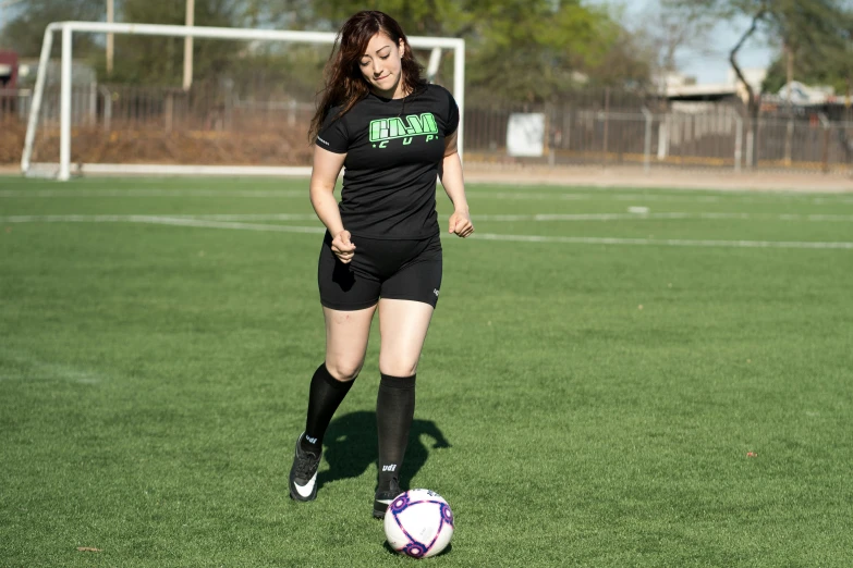 a person in a field with a soccer ball