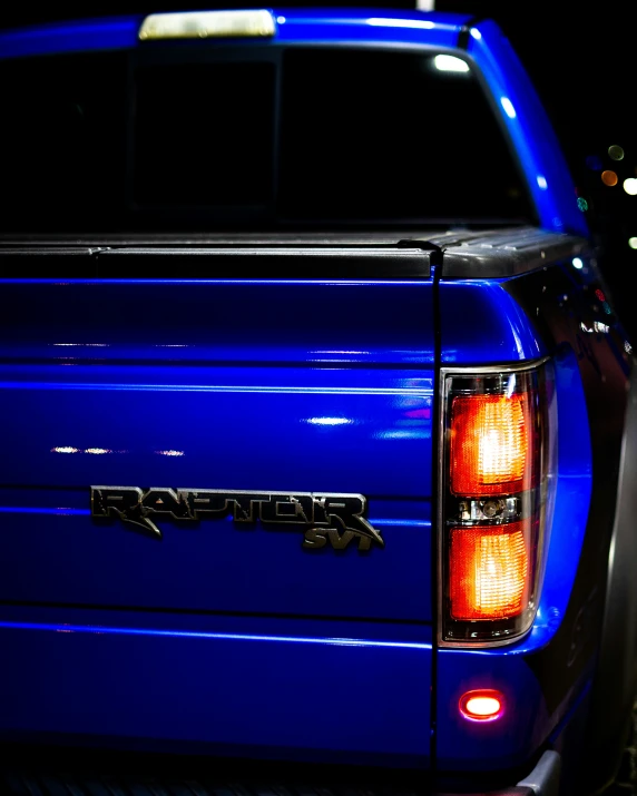 a blue truck parked on top of a sidewalk