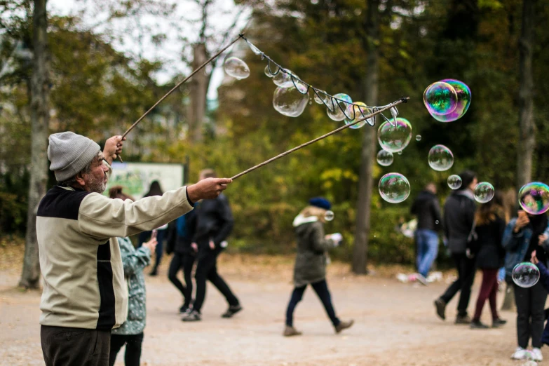 a man in glasses playing with soap bubbles