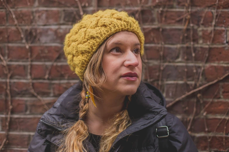 woman in the outdoors wearing a beanie and id