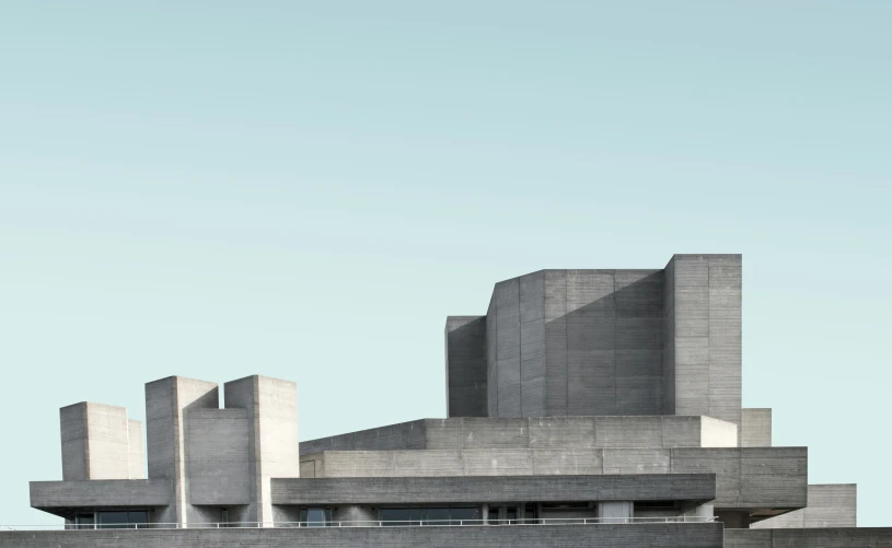 a po of a very tall grey building with a clock on it