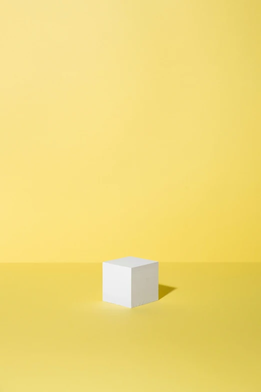 a white block is in front of a yellow background